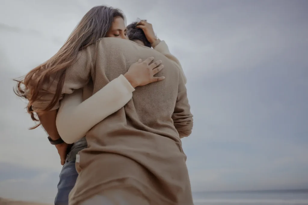 couple hugging during pre-wedding shoot at Varkala Beach